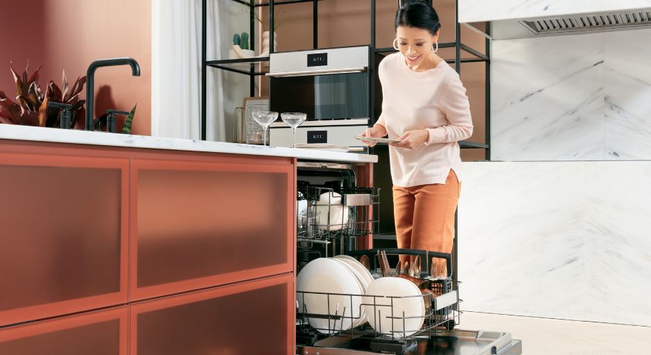 women loading the dishwasher